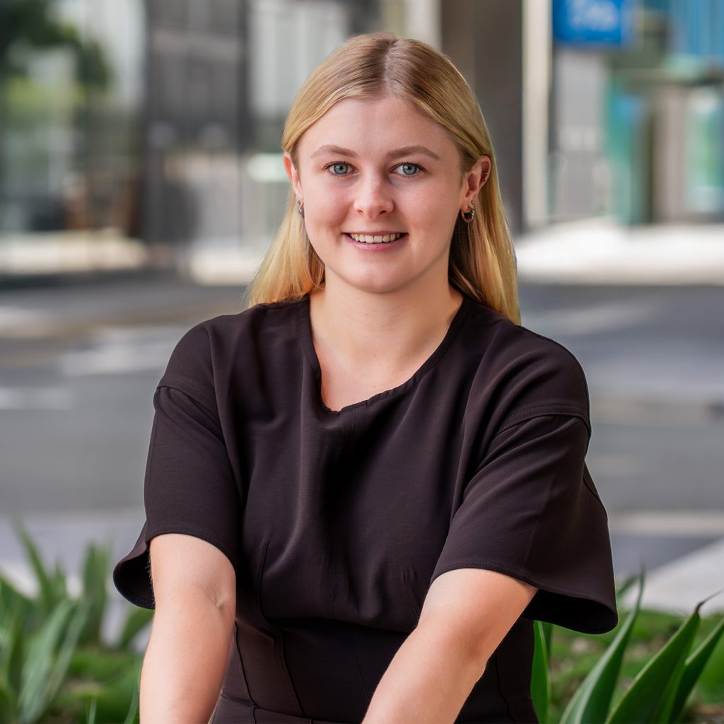 Legal Assistant, Haylee Spedding in the park outside of AX Compensation Lawyers office on the Sunshine Coast